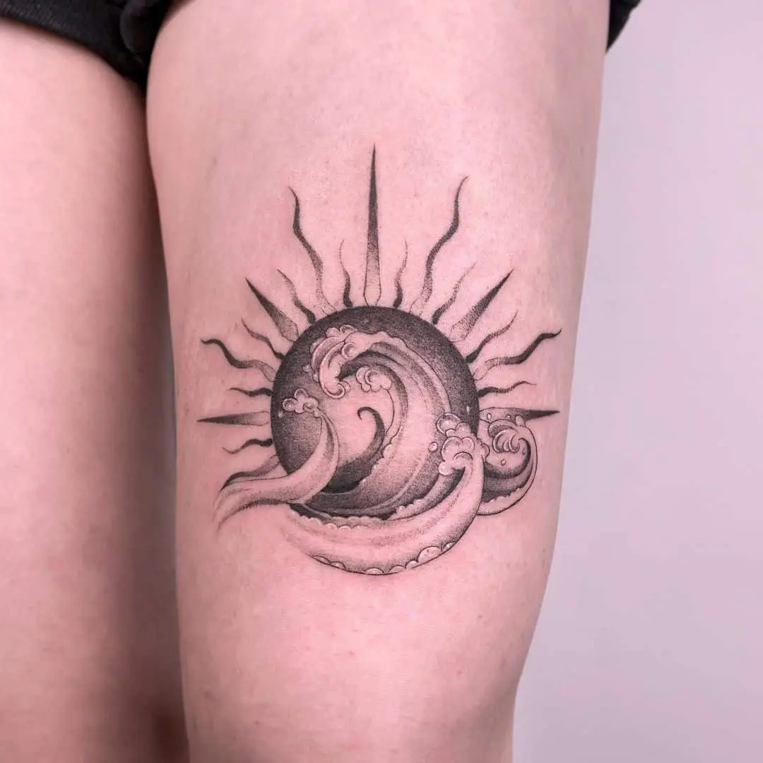 wave and sun tattoo on thigh