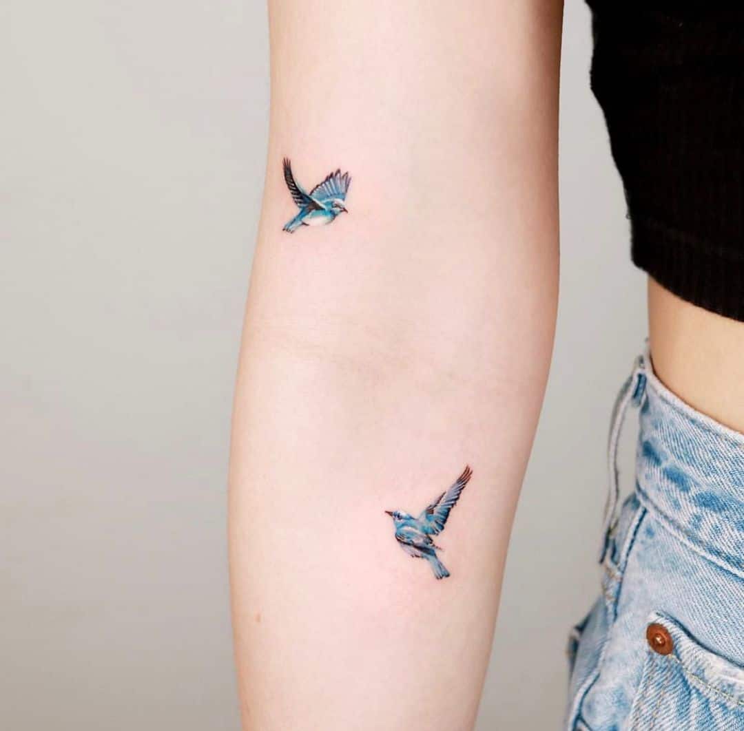 Small Colorful Bird Tattoo