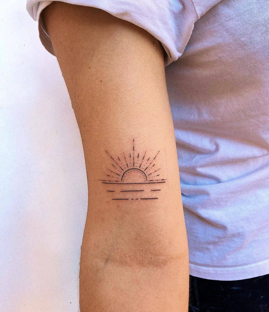 Rising Sun Tattoo on upper arm