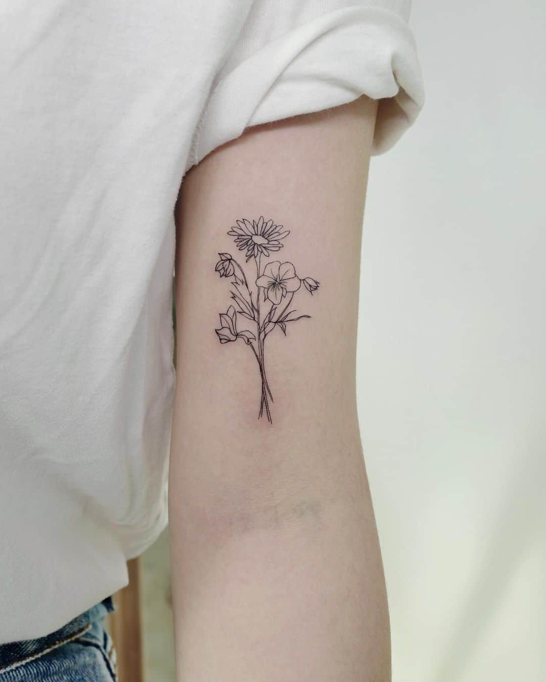 Aster Flower tattoo on arm by tatttoo joojoo