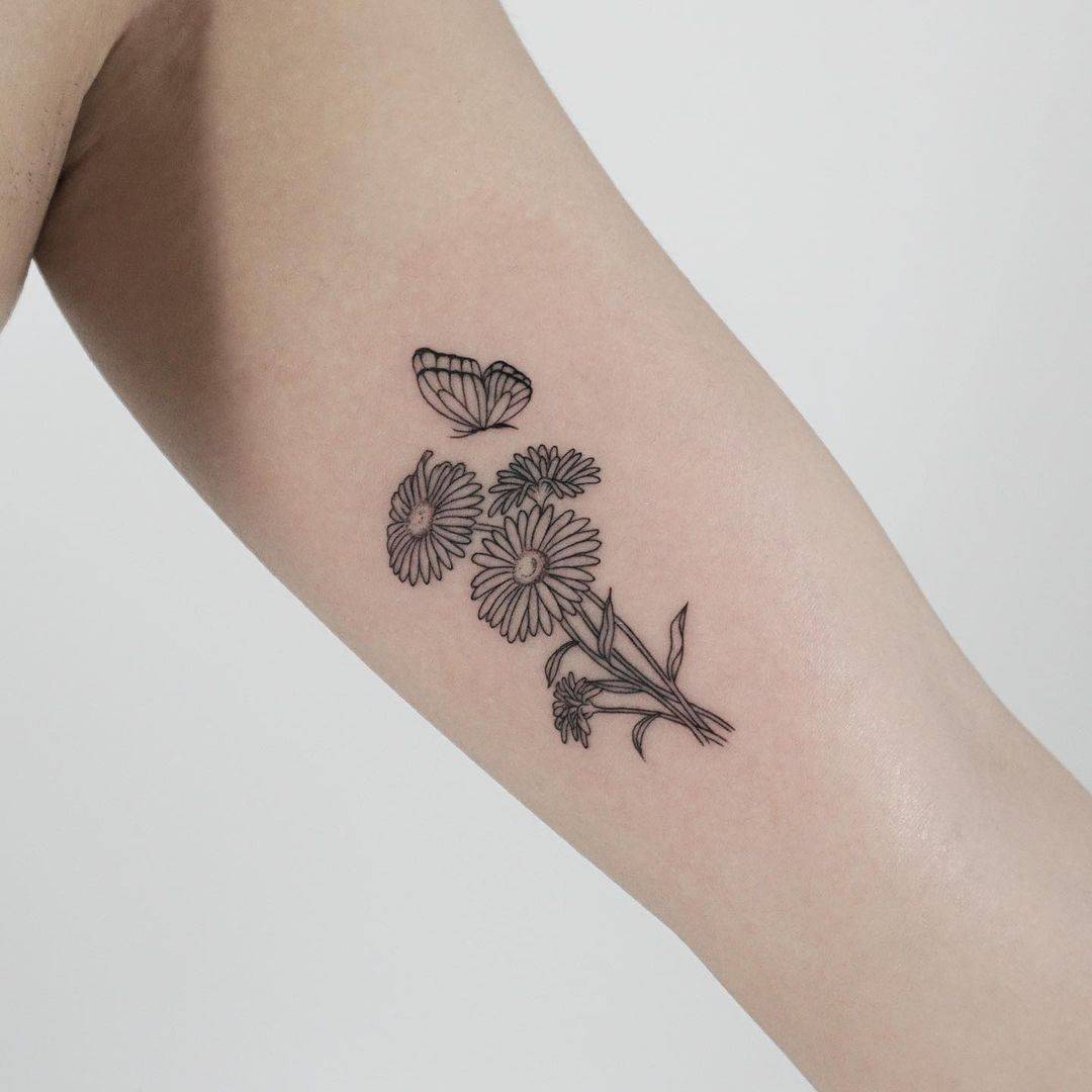 Aster flower tattoo on arm with butterfly by joeysneedle
