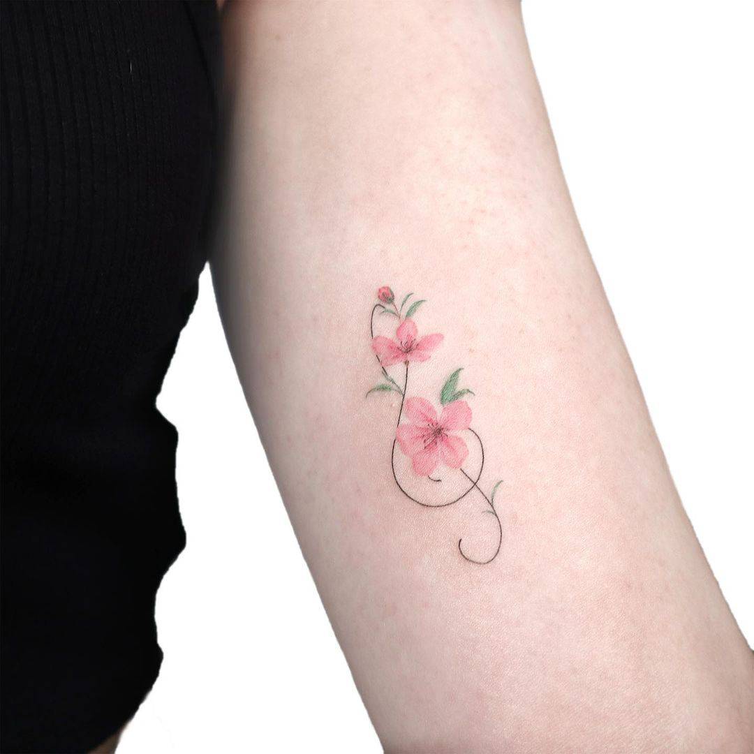 Beautiful cherry blossom flower with music sign by gigi tattooer