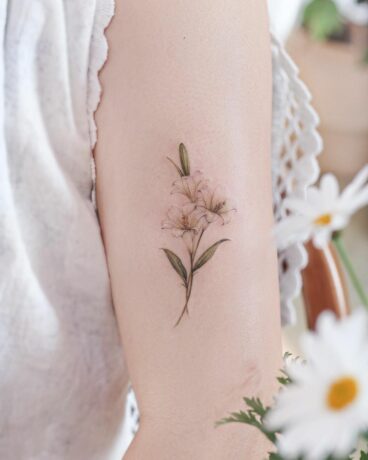 Beautiful lily tattoo on arm by tattoo.haneul
