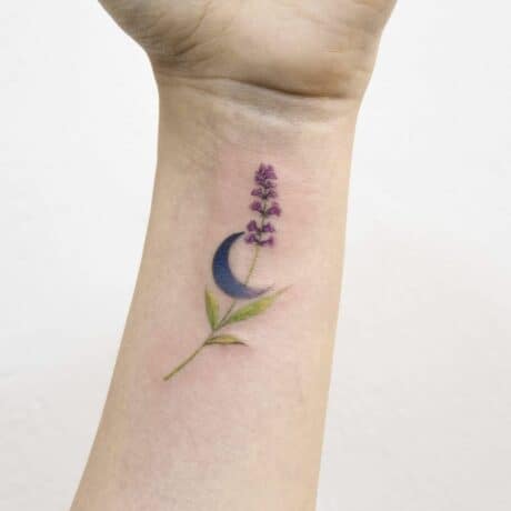 Cute lavender flower tattoo on wrist by arona tattoo
