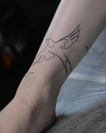 Fine line bird tattoo on foot by sokolova art