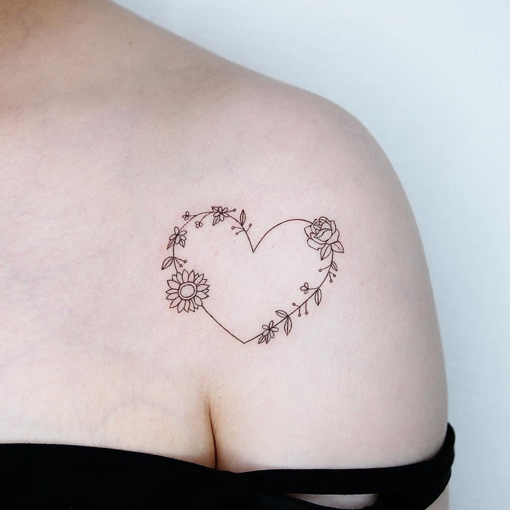 Fineline flower tattoo in heart shape by tattoo.choi