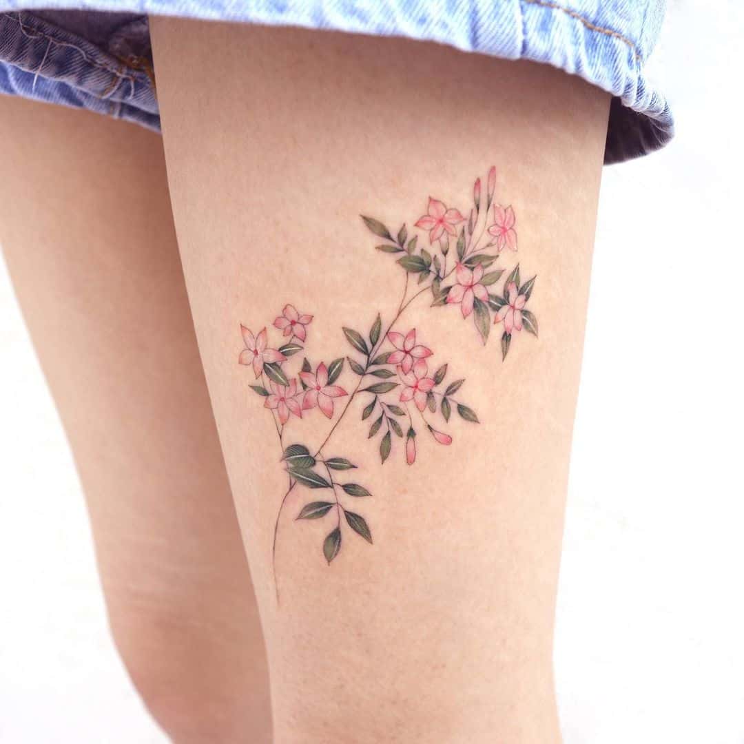 Jasmine tattoo on thigh by studiobysol