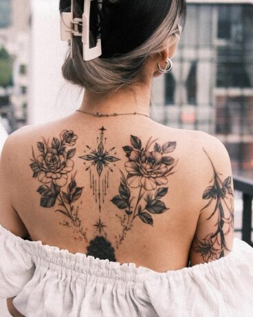 Lily tattoo on back by hwan.ink