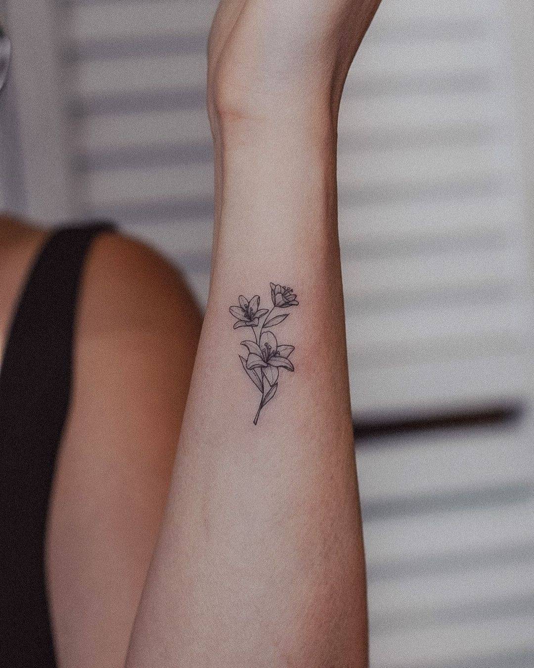 Lily tattoo on wrist by tavi tattoo