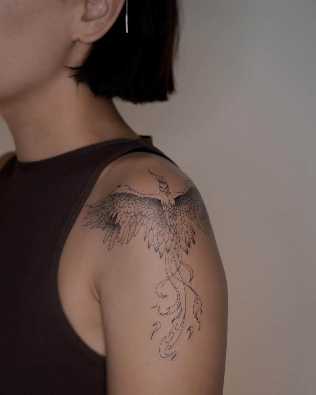 Phoenix tattoo on shoulder by nurai.tattoo