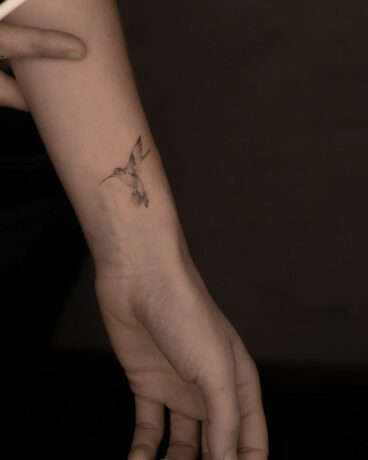 Simple humming bird tattoo on wrist by mid.ttt