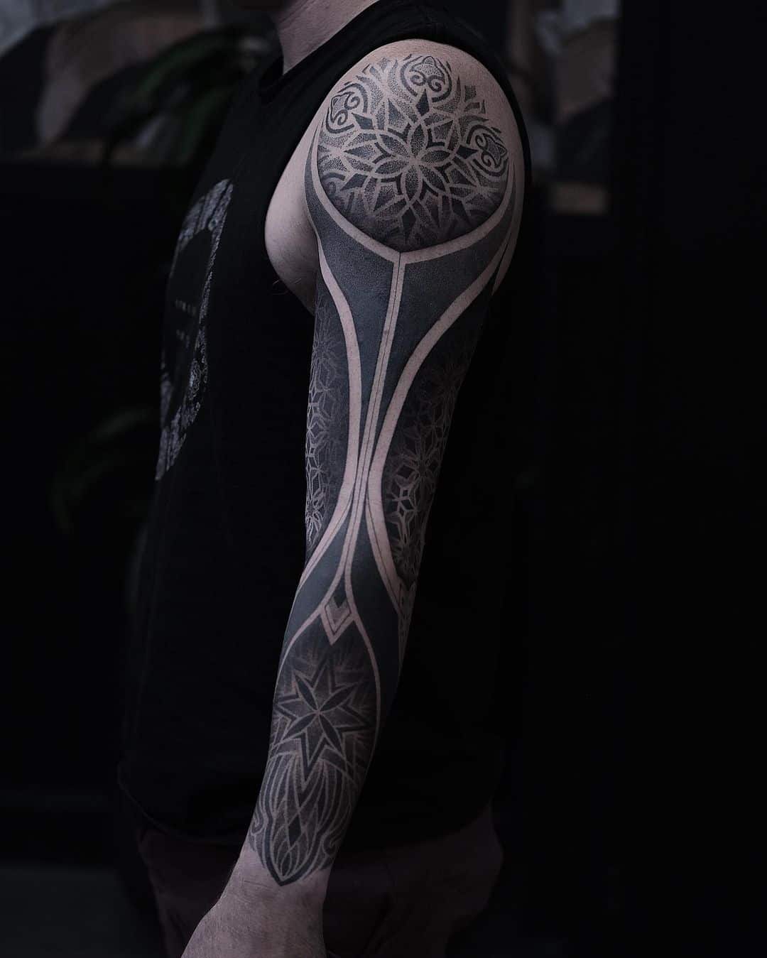 Amazing black ink geometric tattoo on arm by liris.ink