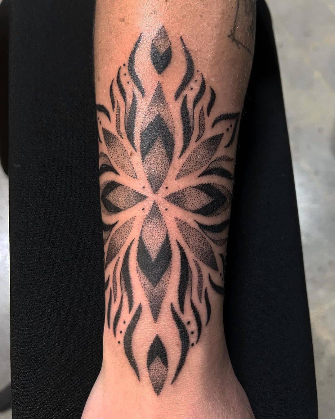 Beautiful geometric tattoo on arm by wajapi tattoo