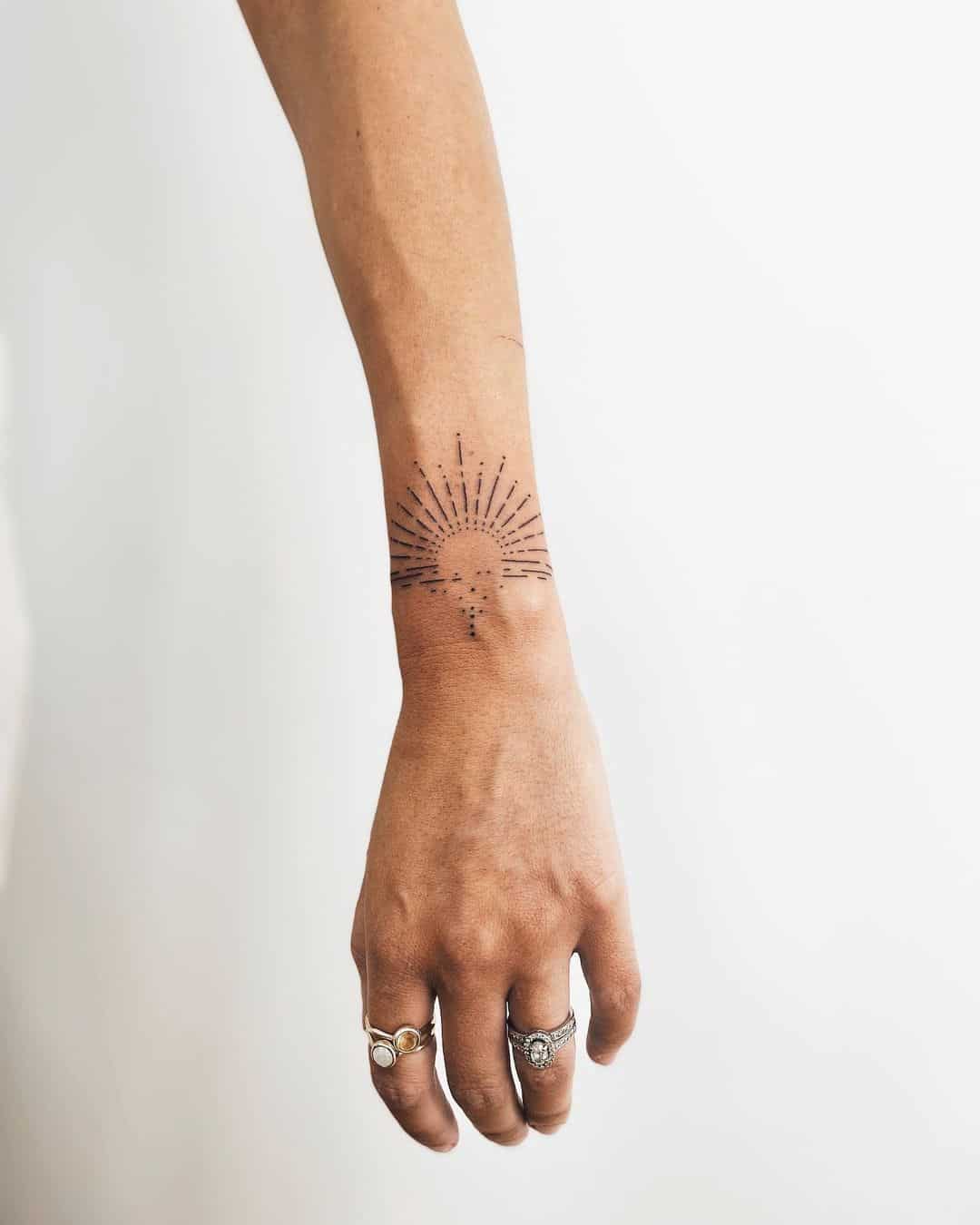 Simple geometric sun tattoo by angustrott tattoo