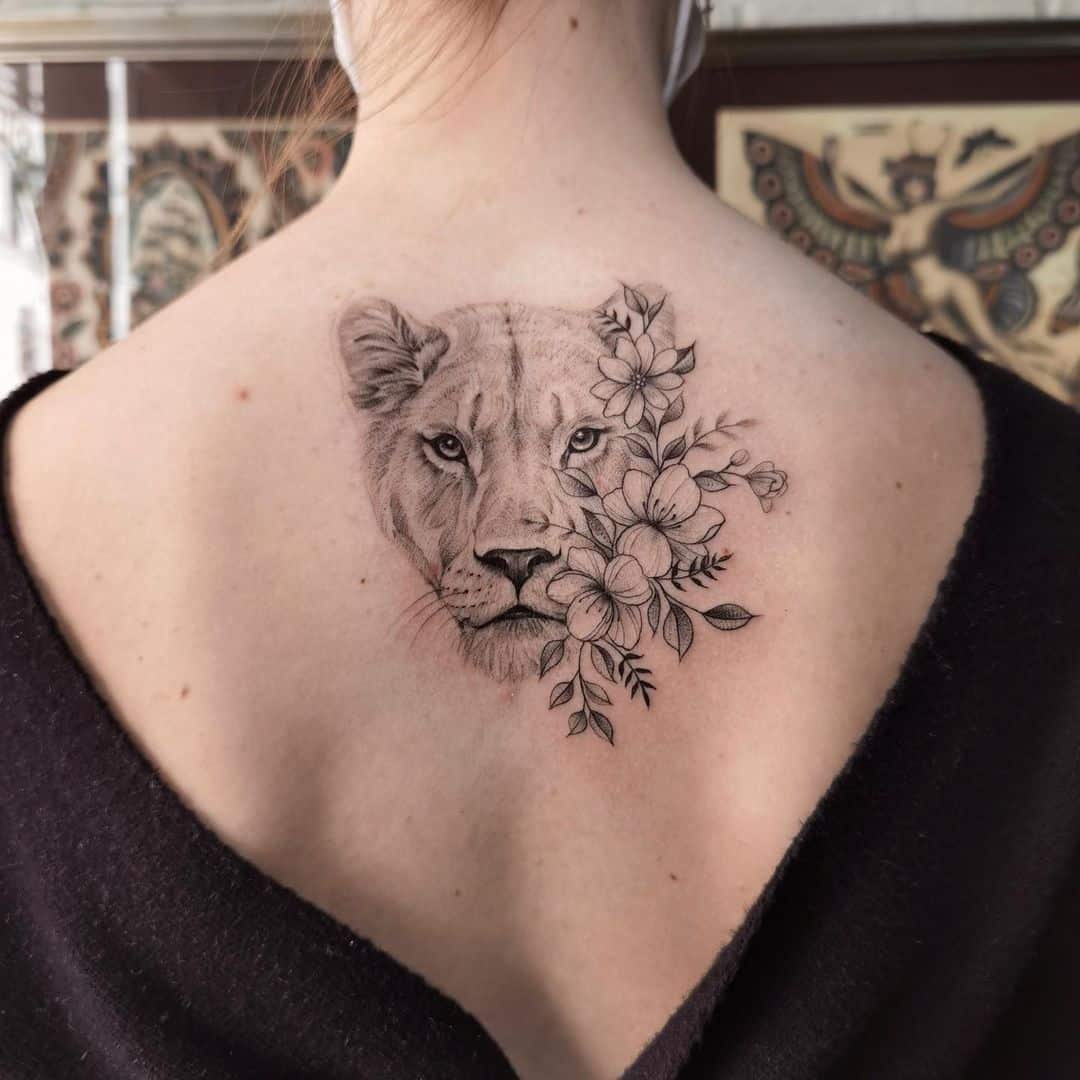 Amazing lioness tattoo on back ith floer by pachamamatattoo elvis