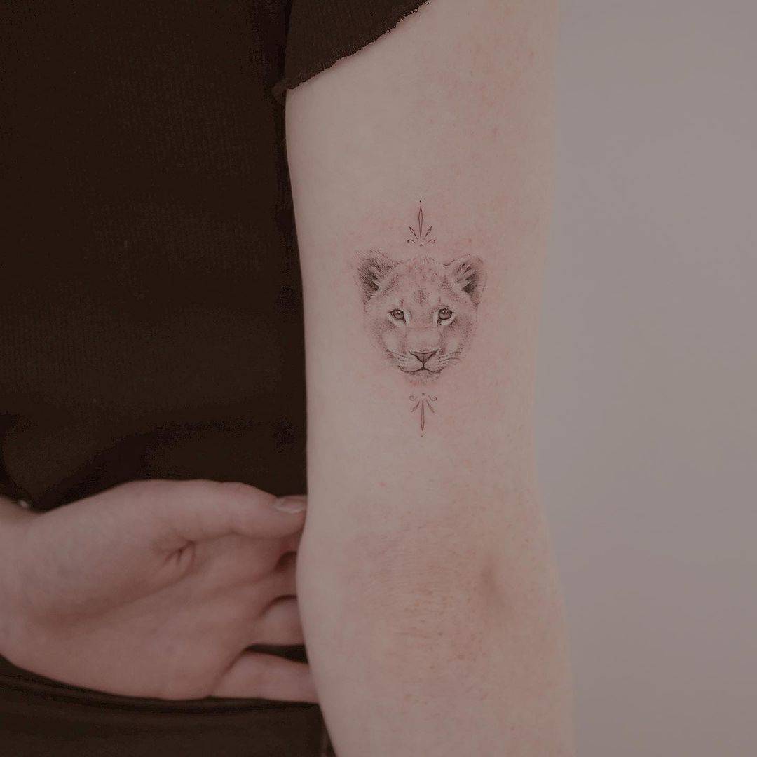 Single needle lioness tattoo on the right inner