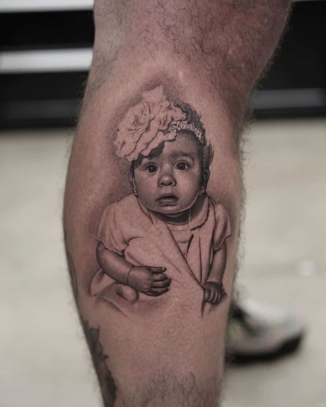 Baby portrait tattoo on leg by adamdeanart