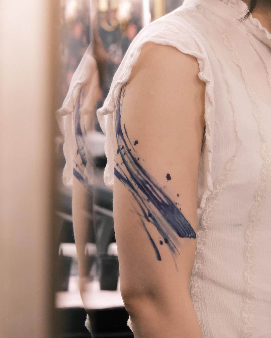 Beaautiful watercolor abstract tattoo on arm by who is ryu