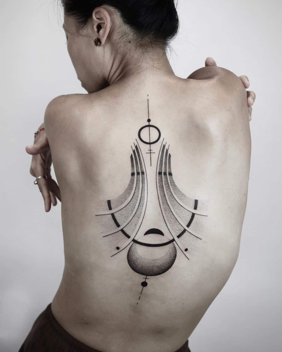 Abstract back tattoo of flying birds