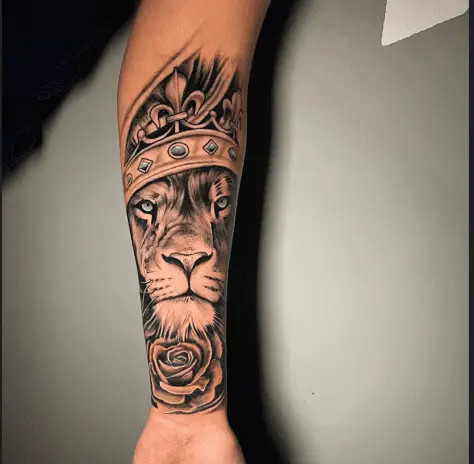 Beautiful lion and crown tattoo on lower arm