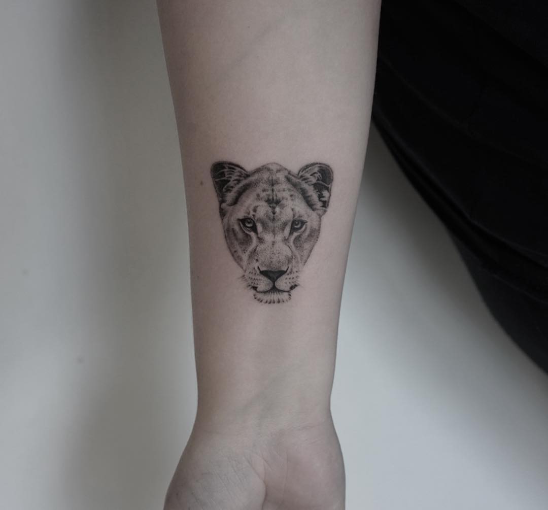 Cute lioness tattoo on forearm by micro man