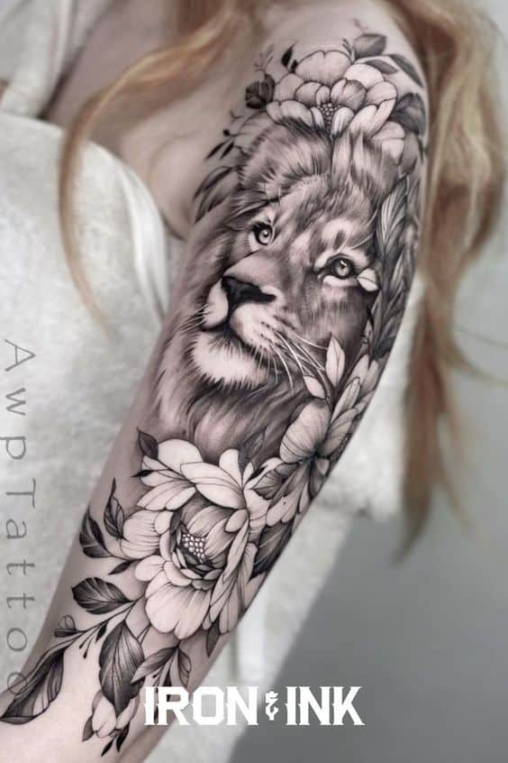 Flower and lion tattoo on upper arm