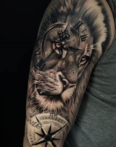 Lion and compass tattoo design on upper arm