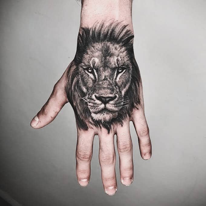 Lion head tattoo on hand by sinergia tattoo studio