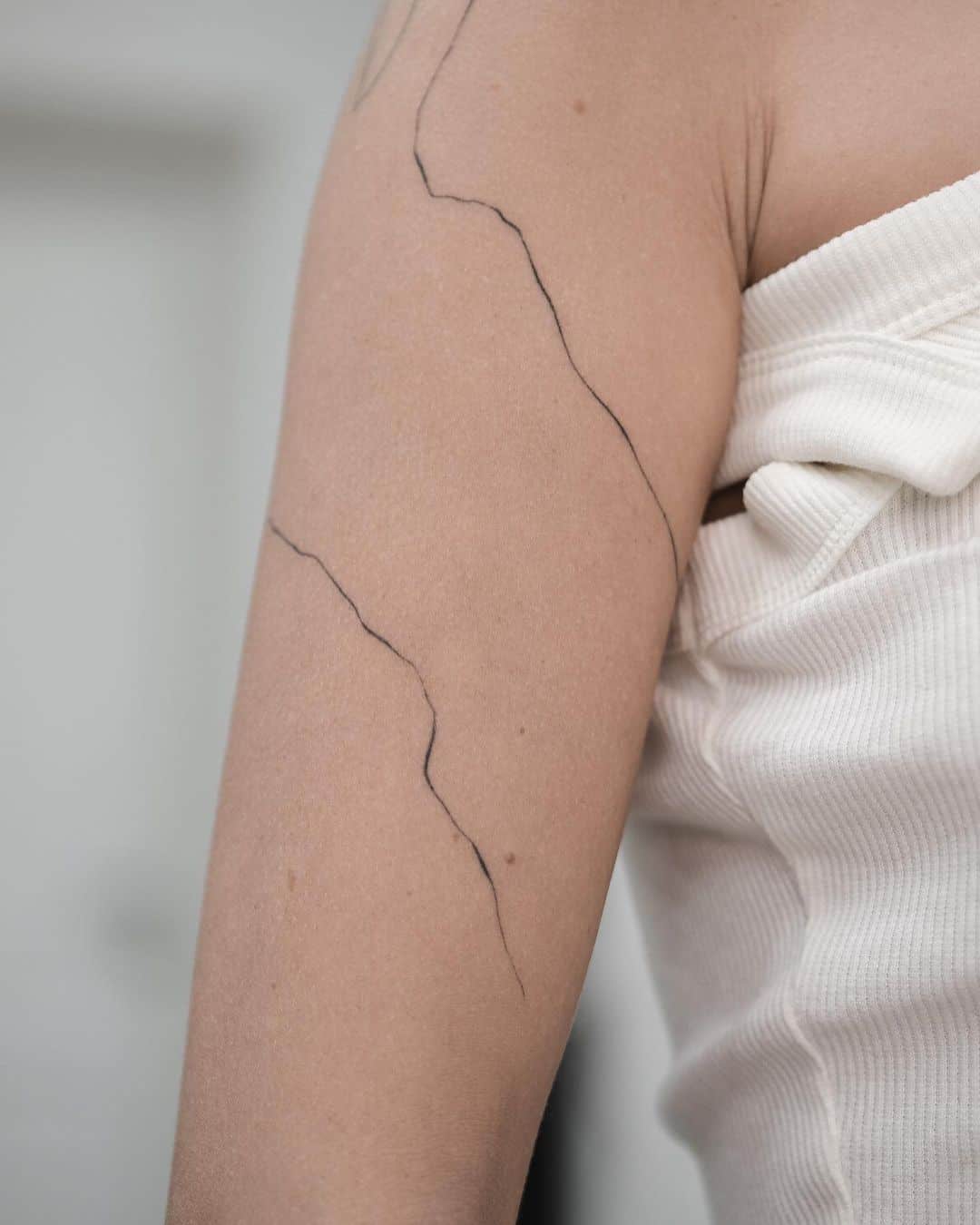 Simple abstract tattoo on arm by arinatattoo