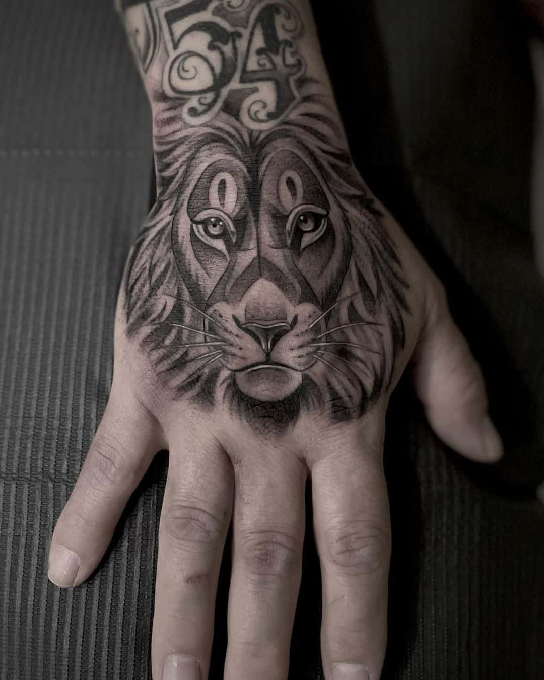 Simple lion tattoo on hand by char tattoos