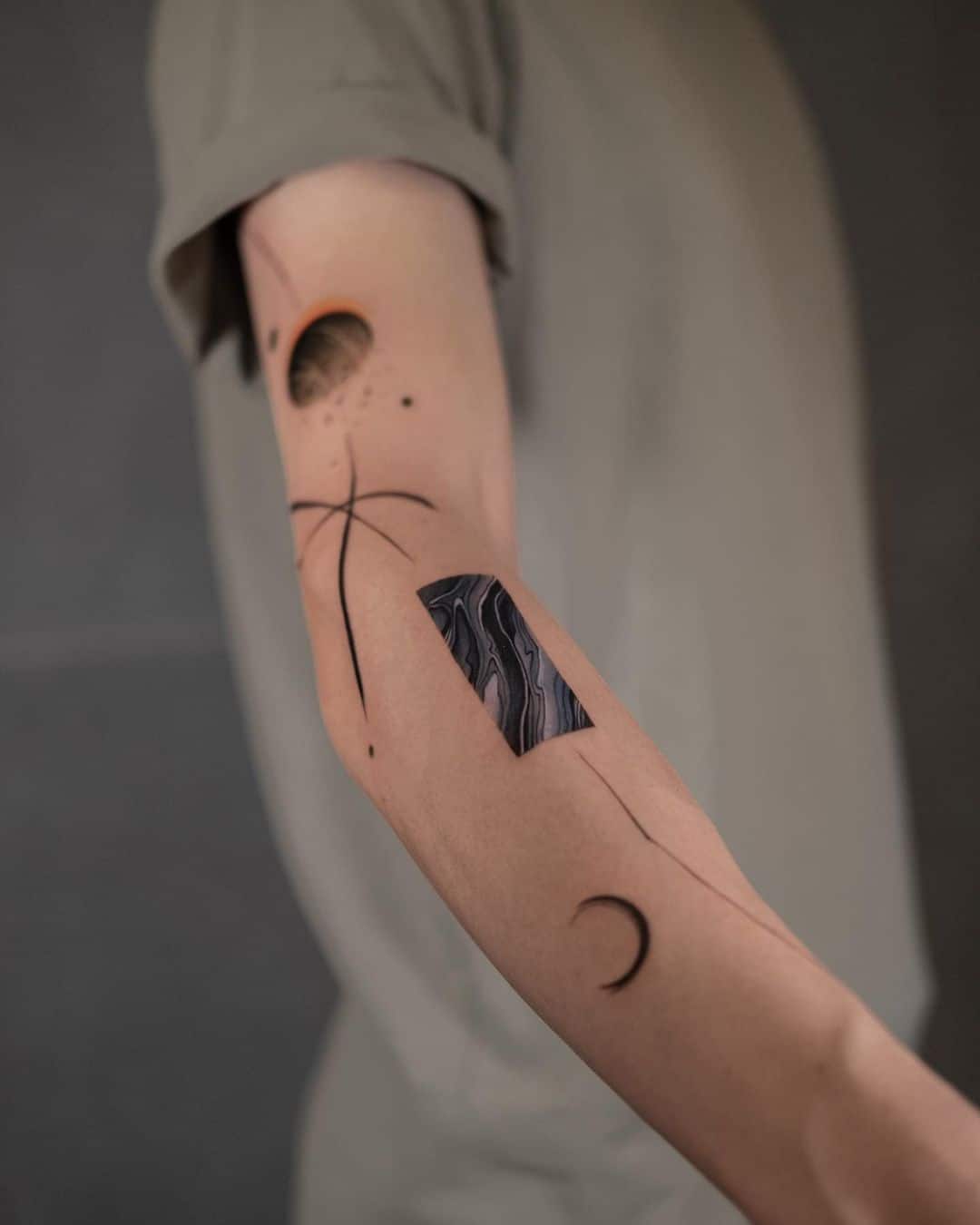 Small asbtract tattoo on forearm by newtattoo demi