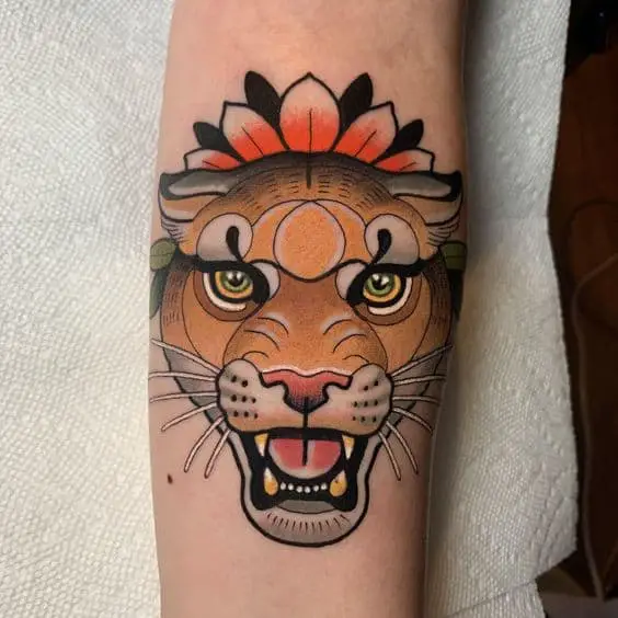 Traditional lioness tattoo on arm