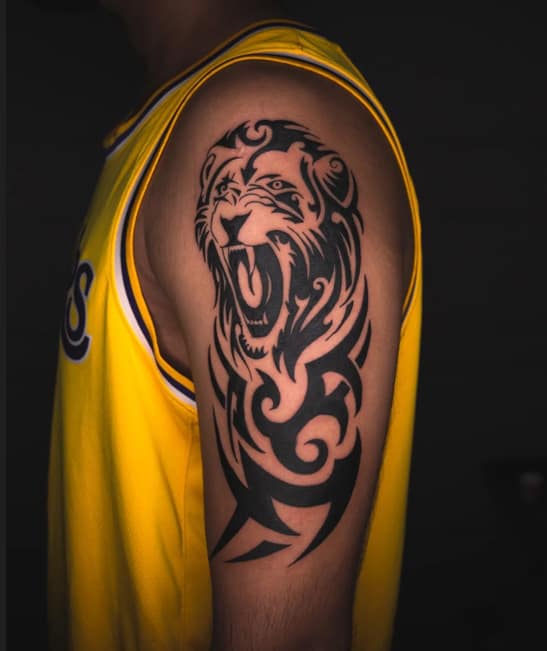 Trobal lion tattoo on upper arm