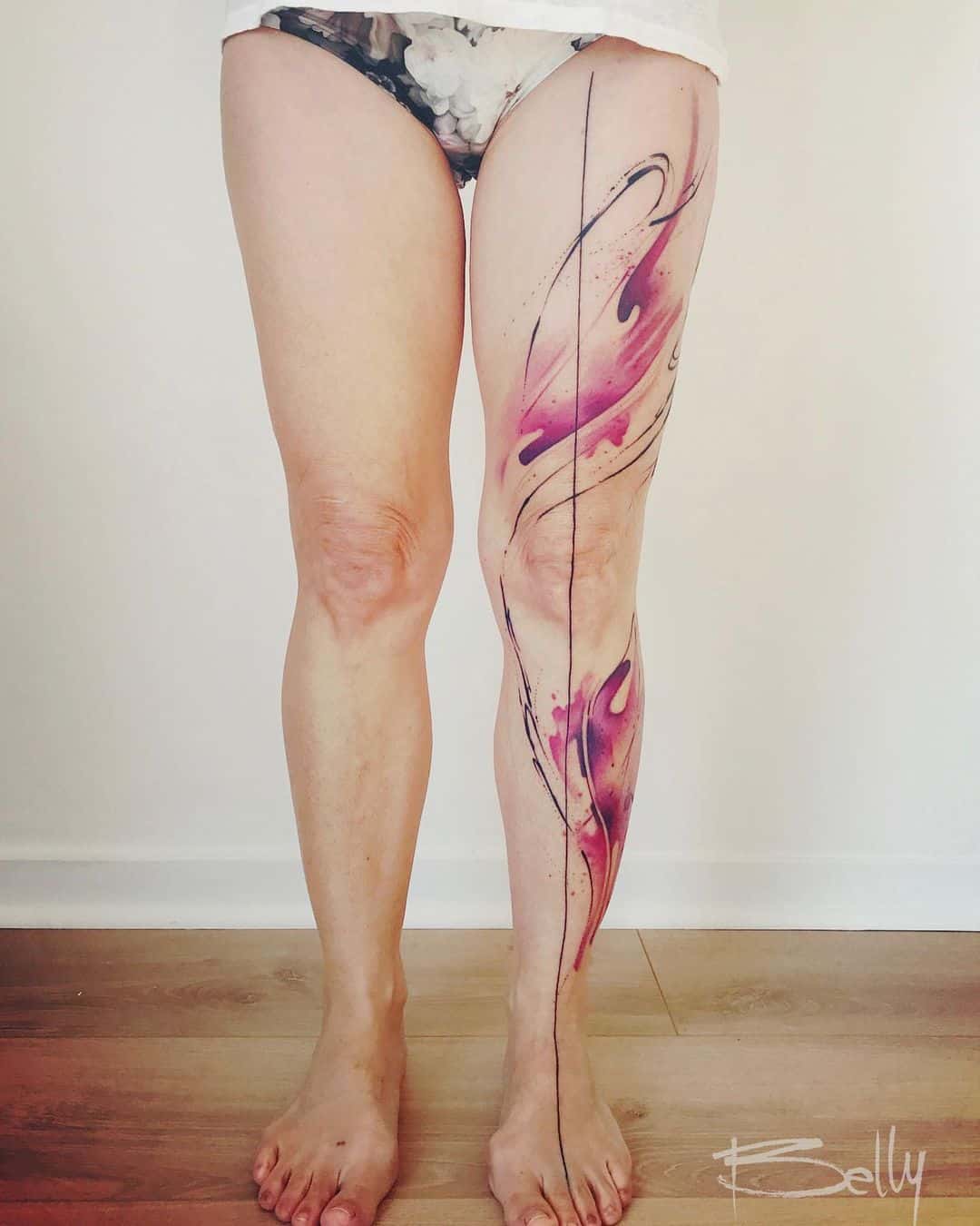 Watercolor abstract tattoo on leg by bellybutton tattoo