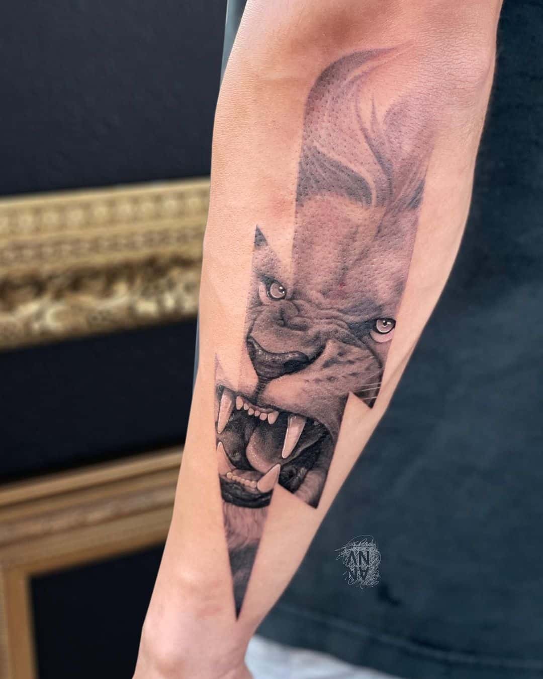 fierce lion tattoo on forearm