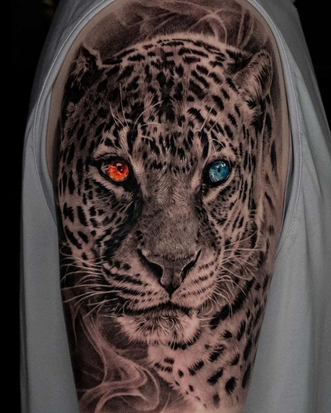 Beautiful leopard portrait with different eye colors by tattooist bega