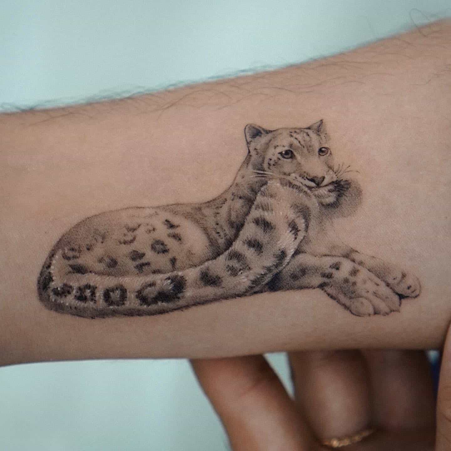 Beautiful snow leopard tattoo design by abii tattoo