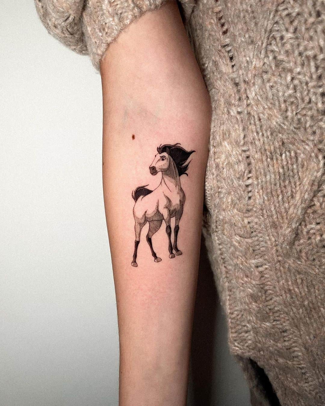 Black and white horse tattoo on arm by turner tattoos