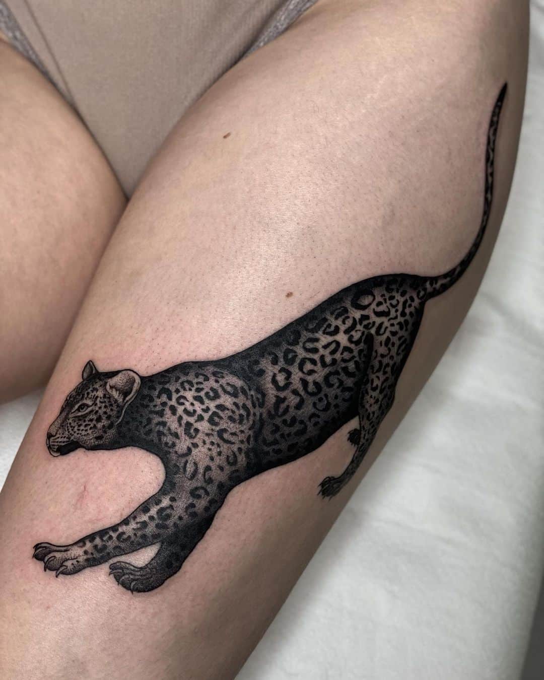 Black leopard tattoo design by spence.tattoos
