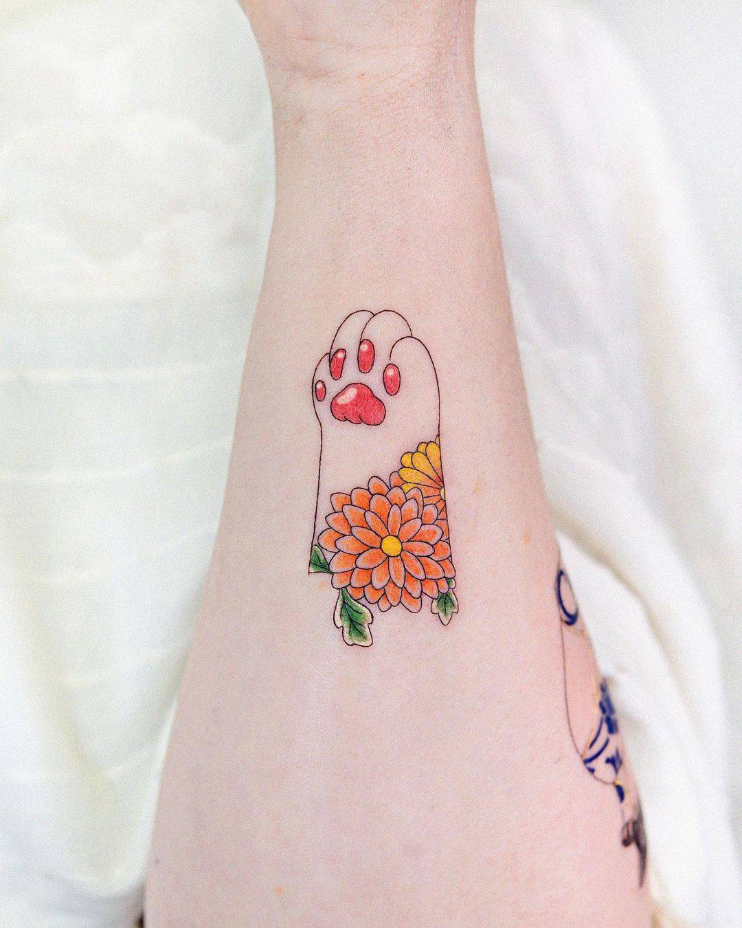 Colorful cat paww tattoo design by adelaide.tattooing