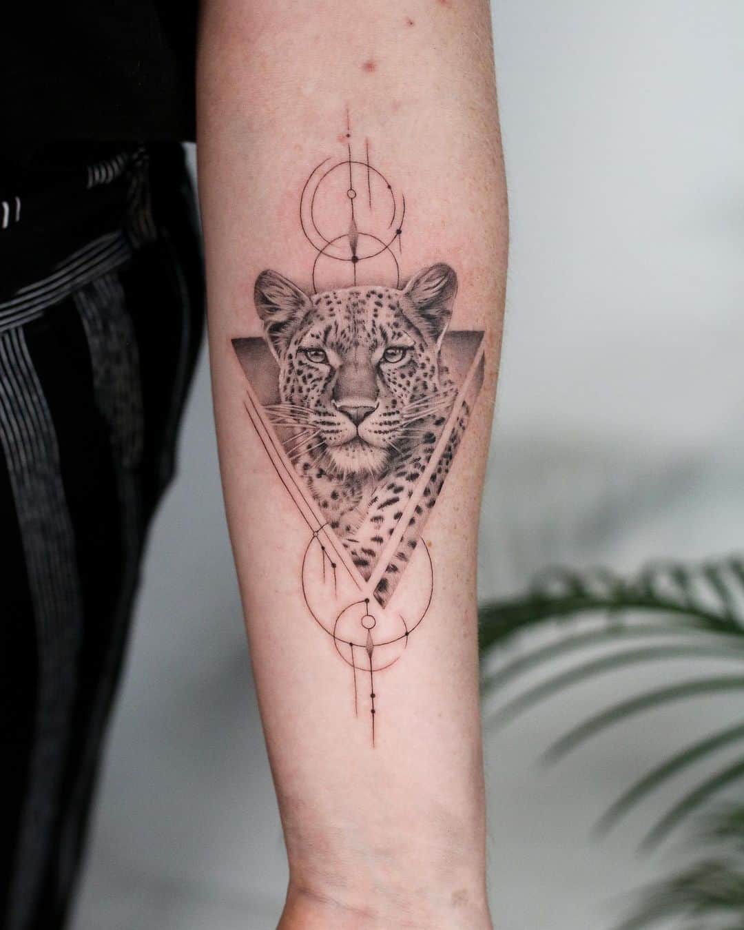 Geometric leopard tattoo on arm by rachaelsawtelltattoo