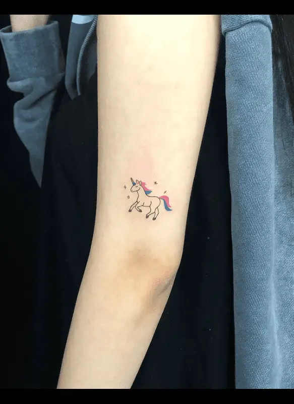 Minimalistic unicorn tattoo on arm by tattooer colin