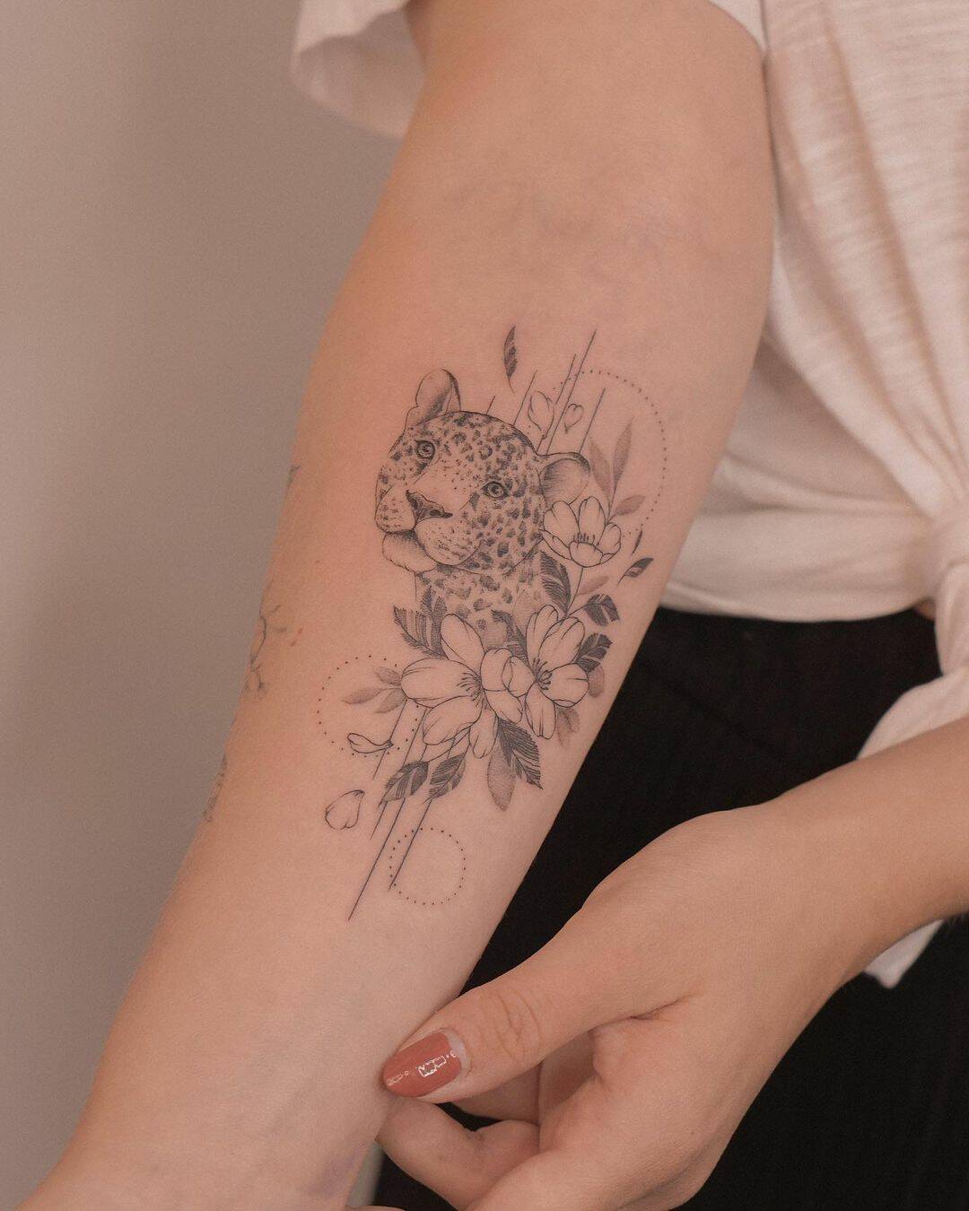 Small leooprd tattoo with flower with flowers by sabyminaart