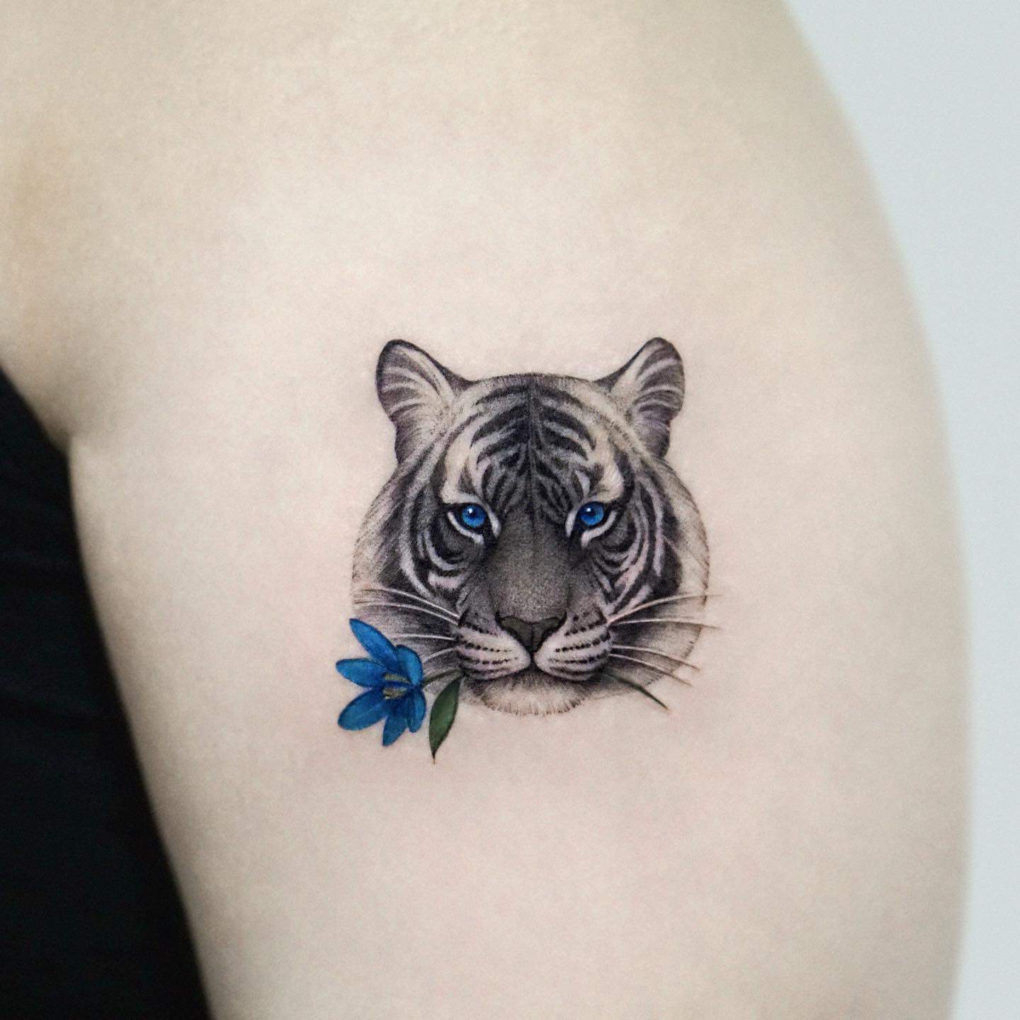 Small tiger tattoo design by sia tattooer