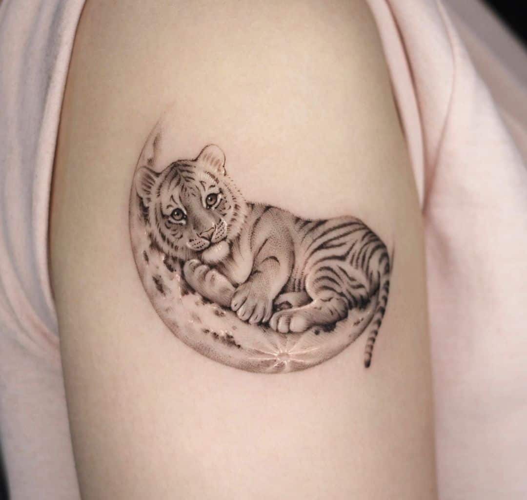 Small tiger with moon tattoo by tattooist dh