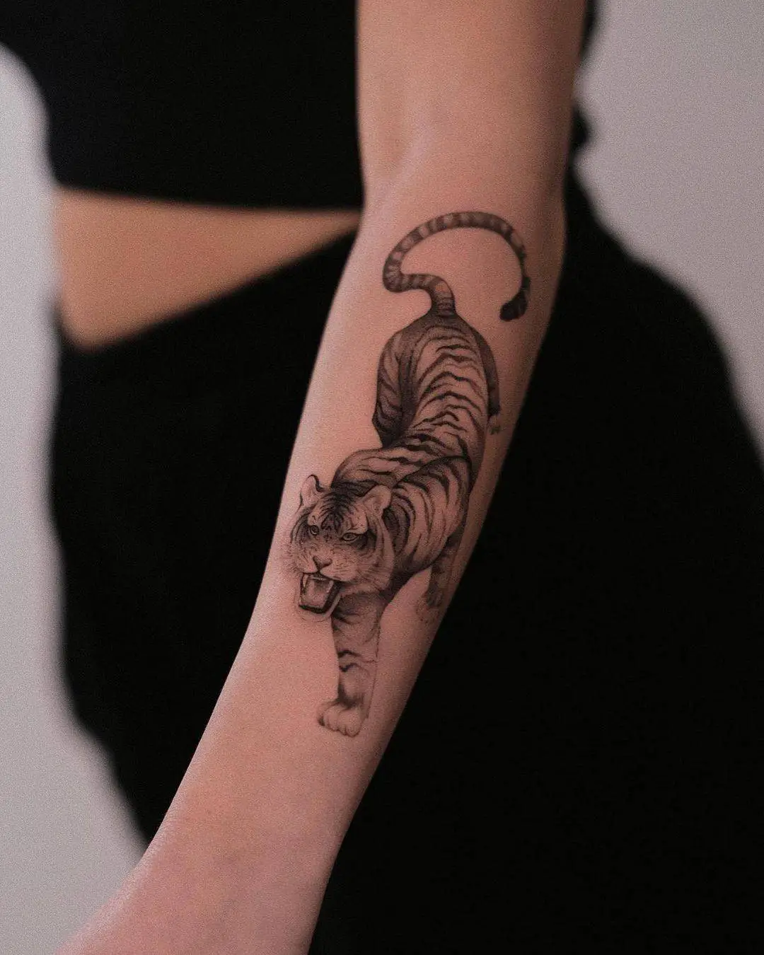 Amazing black and gray tiger on lower arm by ego.romantic