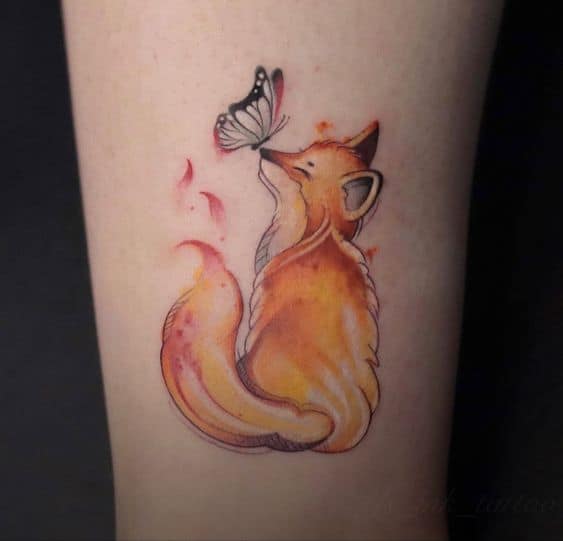 Baby fox tattoo with butterfly