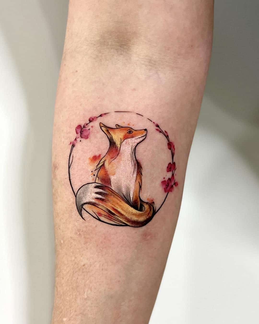 Fox with flower tattoo design on arm by blackwantattoouppsala