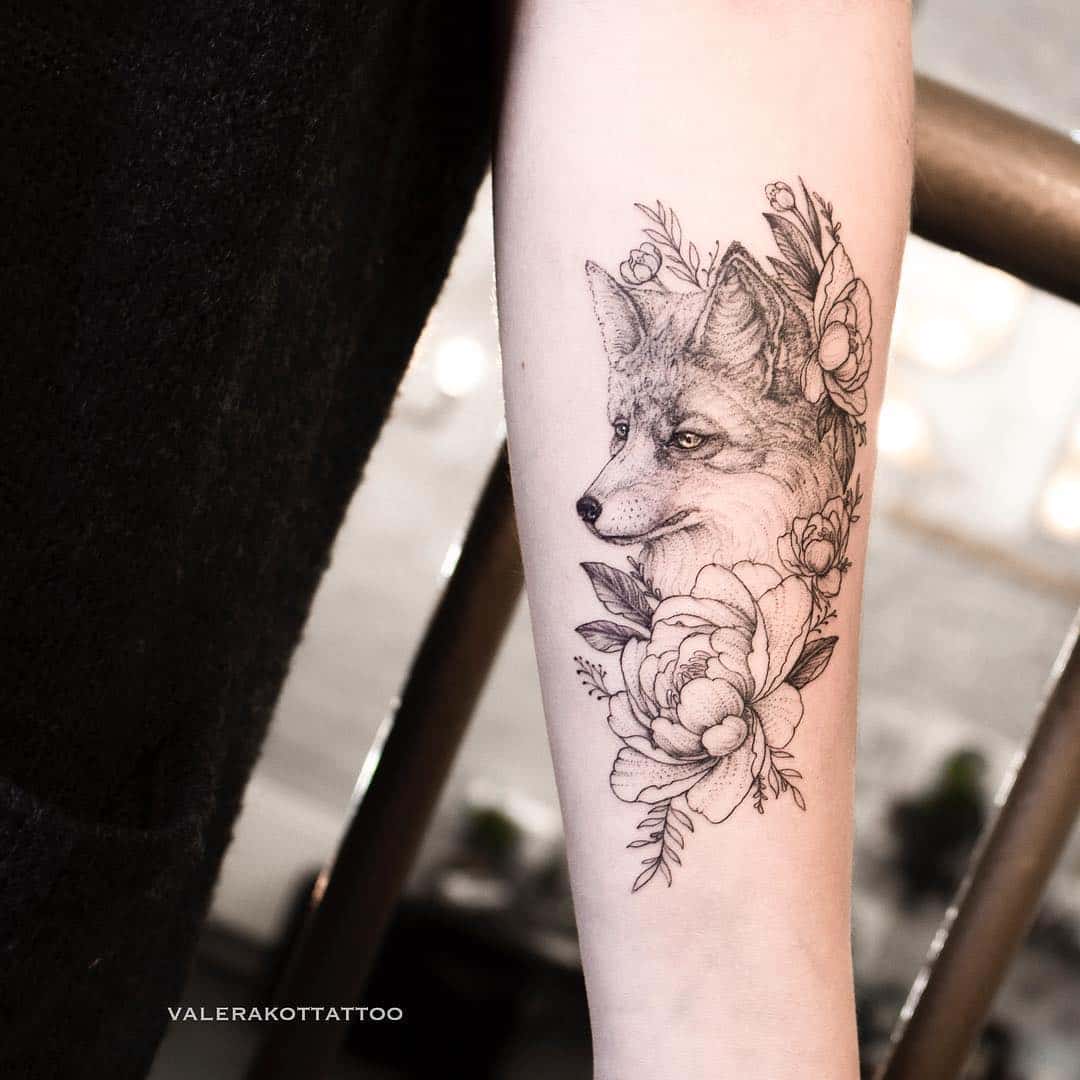 Fox with flower tattoo on lower arm by valerakottattoo
