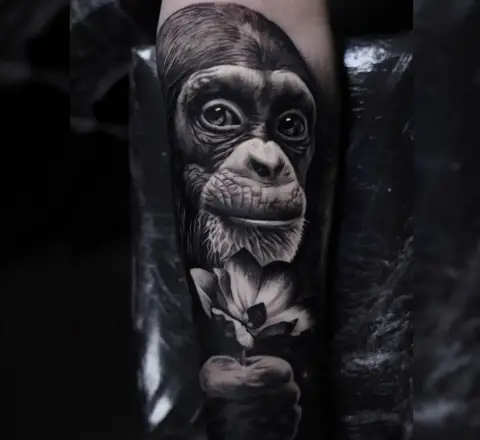 Monkey with flower tattoo by ohanna tattoo